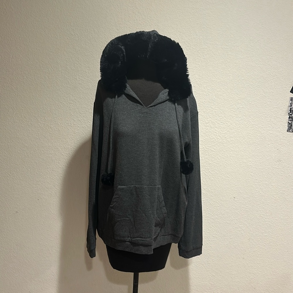 Gray pullover sweatshirt with lined hood and fur pompoms